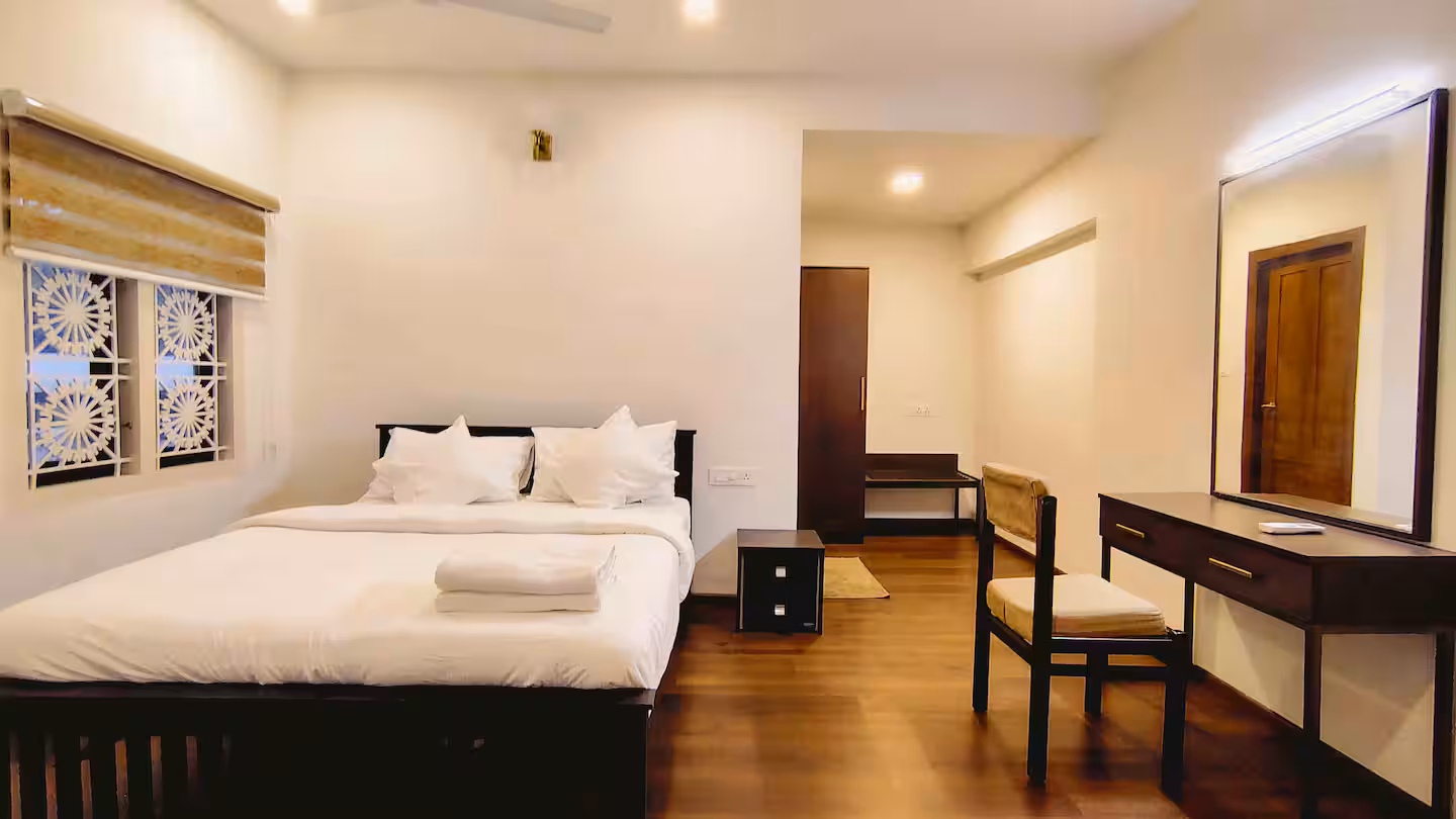 Air-conditioned Bedroom 2 featuring a comfortable Queen-sized bed in Thiruvalla homestay